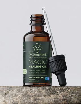 DK Botanicals Magic Healing Oil bottle with dropper on a gray background